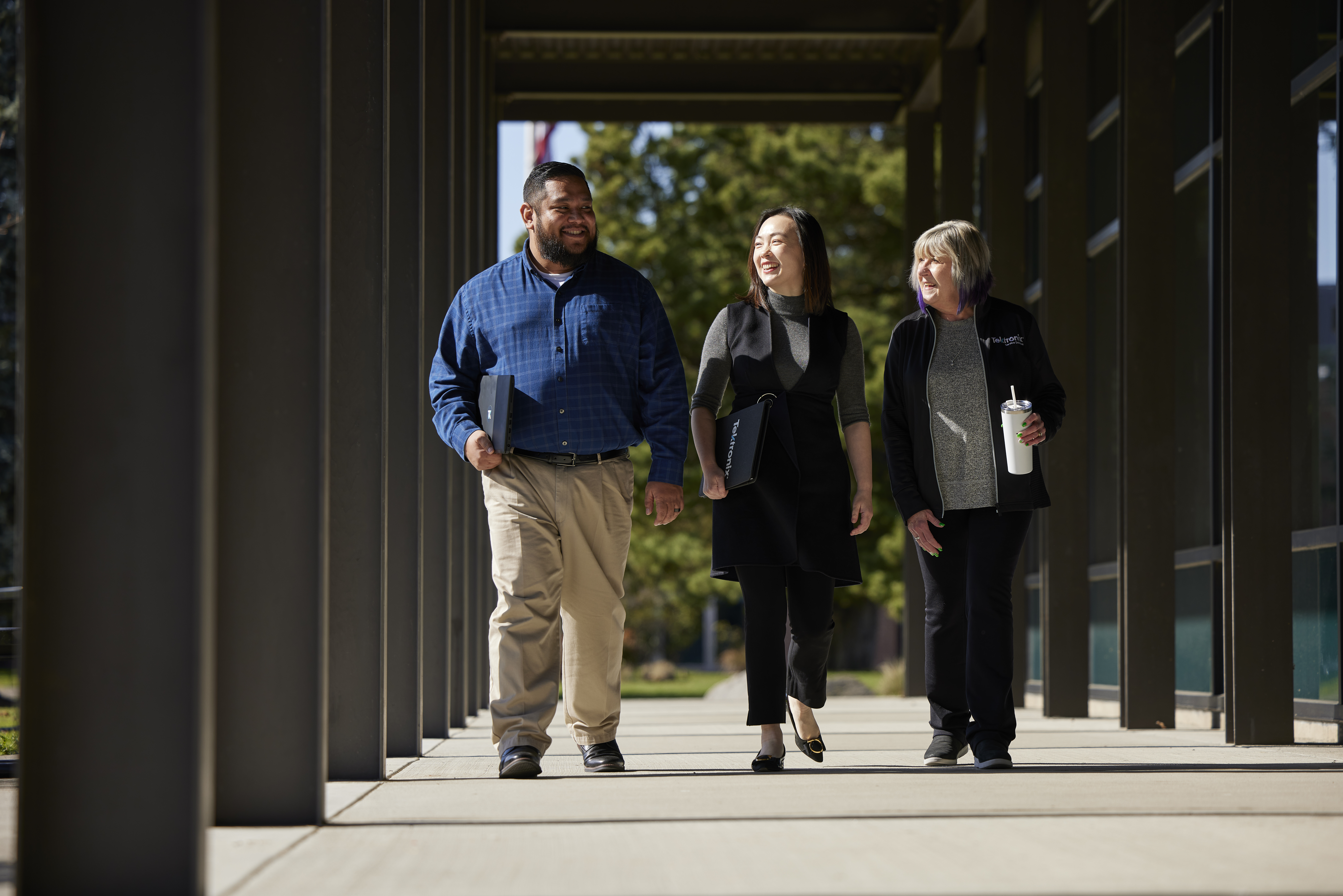 Tektronix employees smiling on a walk around Beaverton campus