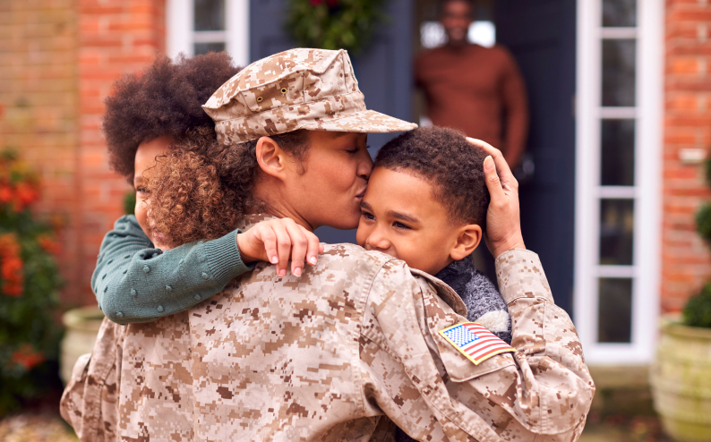A solider greets her 2 children